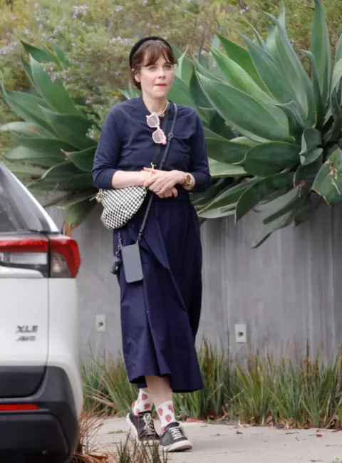 Zooey Deschanel Enjoys a Serene Morning Stroll in Picturesque Venice 08-15-2025