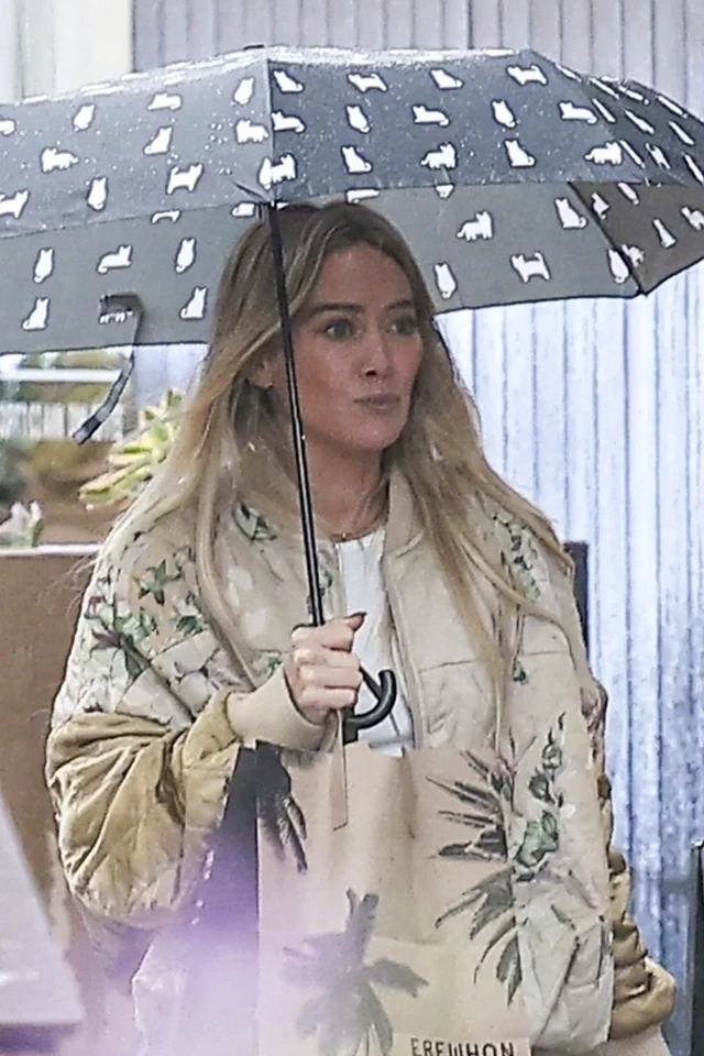 Hilary Duff Spotted Shopping for Eyewear and Enjoying an Iced Coffee in Rainy Los Angeles 11-20-2025